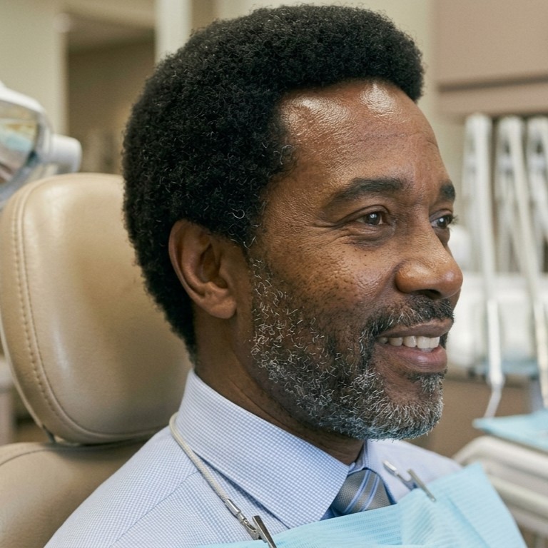A smiling older male patient